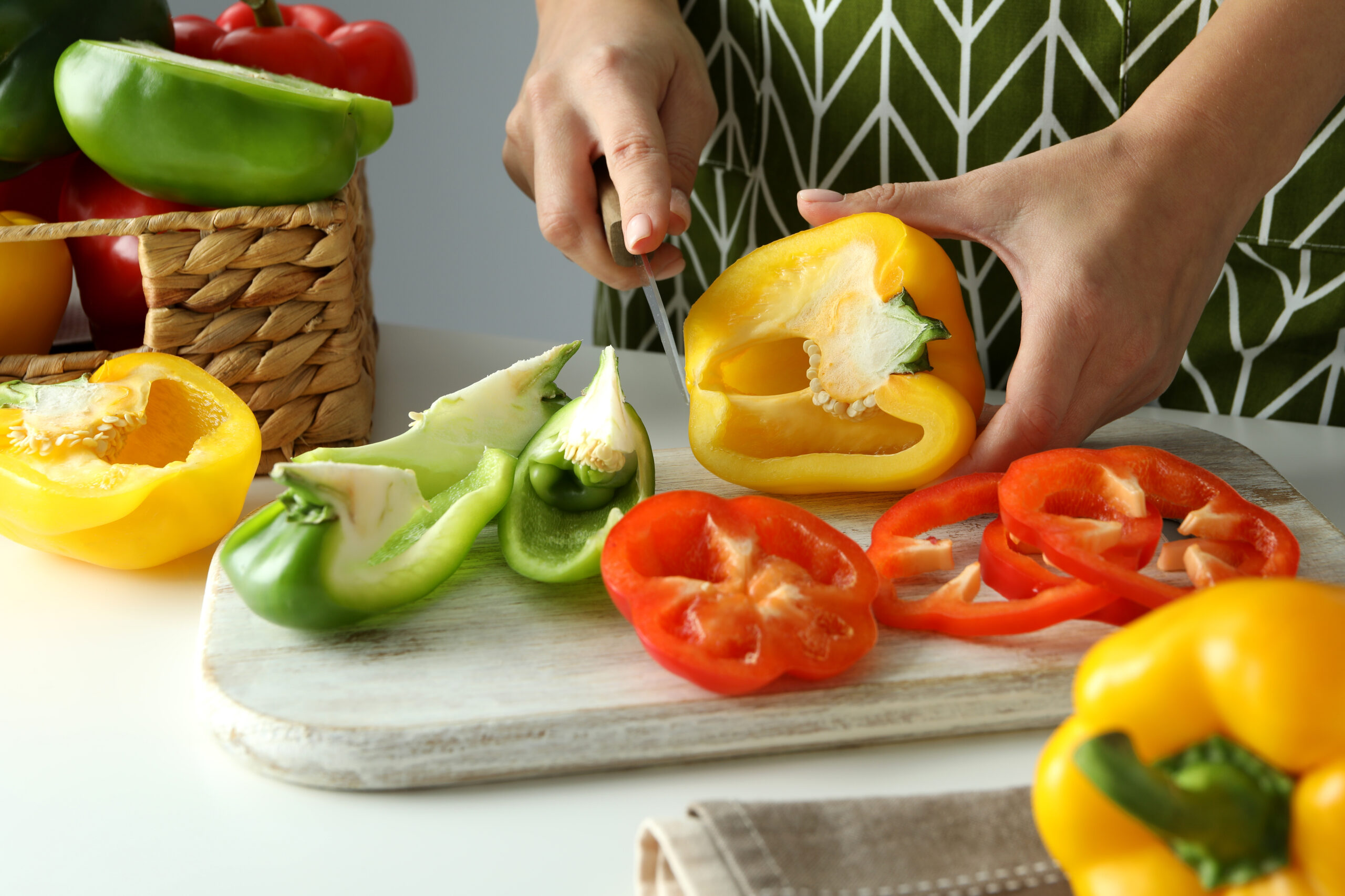 woman hands cut bell pepper on white board 2022 01 19 00 22 09 utc scaled